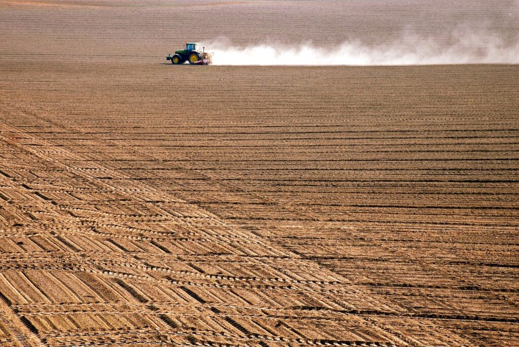 Tractor working a large farm field