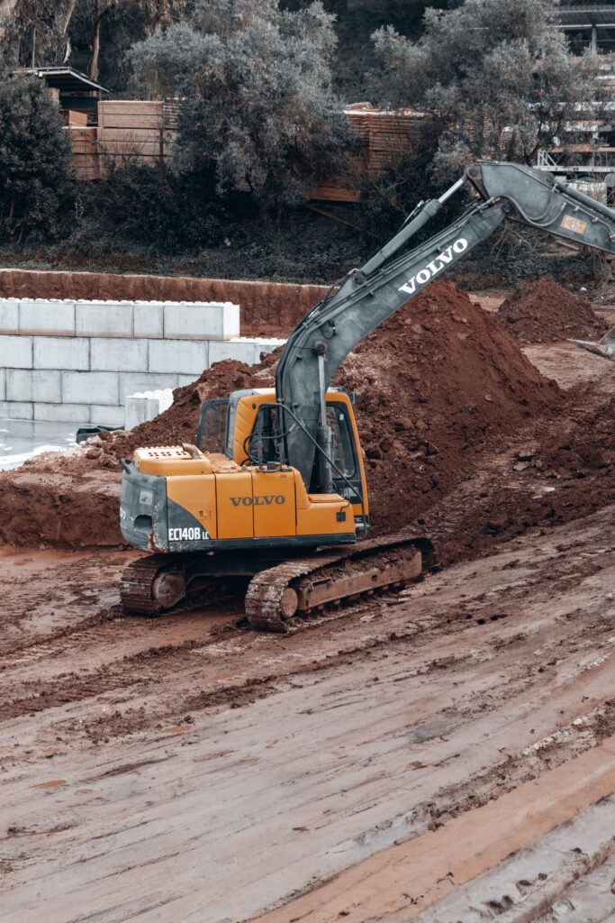 Excavator moving earth on an active construction site